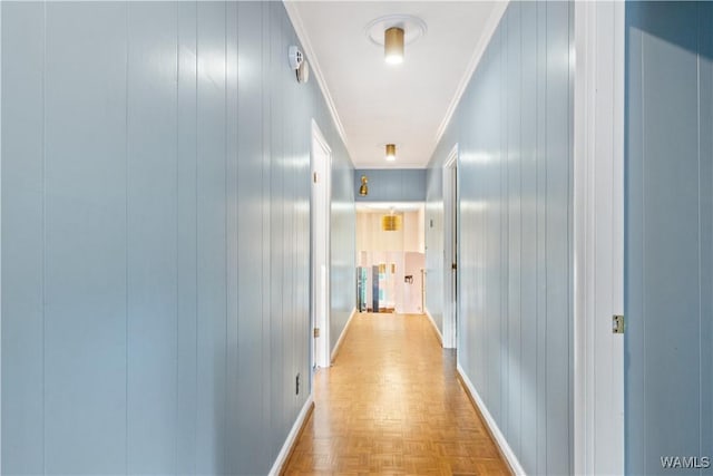 hallway with crown molding and baseboards