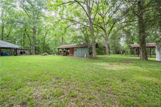 221 3rd Ct SW, Fayette, AL 35555 - view of grassy yard with a pole building and an outbuilding
