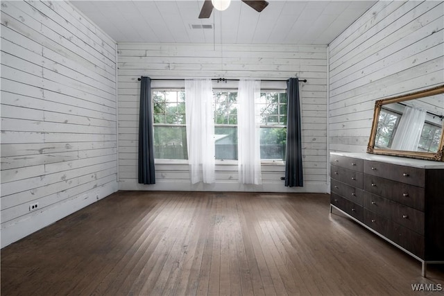 221 3rd Ct SW, Fayette, AL 35555 - spare room with wood walls, dark wood-type flooring, and a ceiling fan