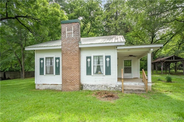 221 3rd Ct SW, Fayette, AL 35555 - view of front of house featuring covered porch, a chimney, a ceiling fan, and a metal roof