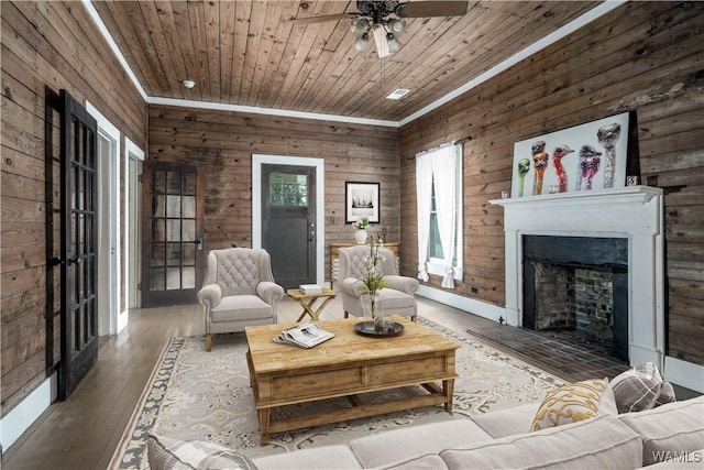 221 3rd Ct SW, Fayette, AL 35555 - living room featuring a fireplace, ceiling fan, wood walls, hardwood / wood-style flooring, and wood ceiling