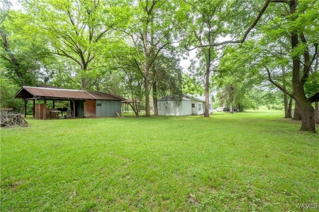 221 3rd Ct SW, Fayette, AL 35555 - view of green lawn with an outdoor structure and an outbuilding