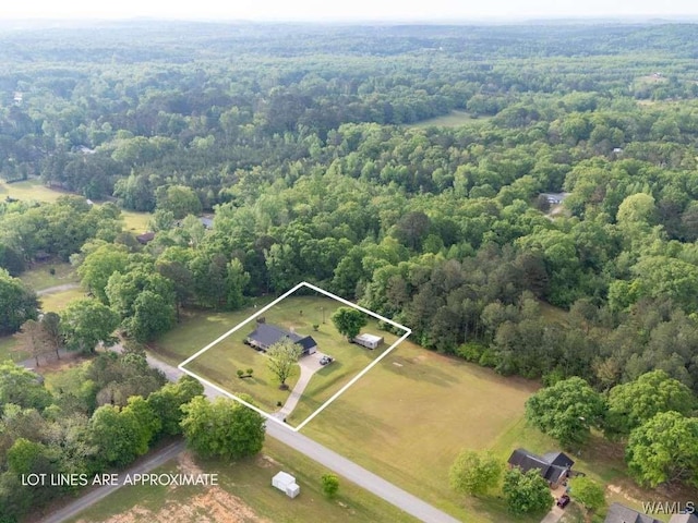 birds eye view of property featuring a wooded view