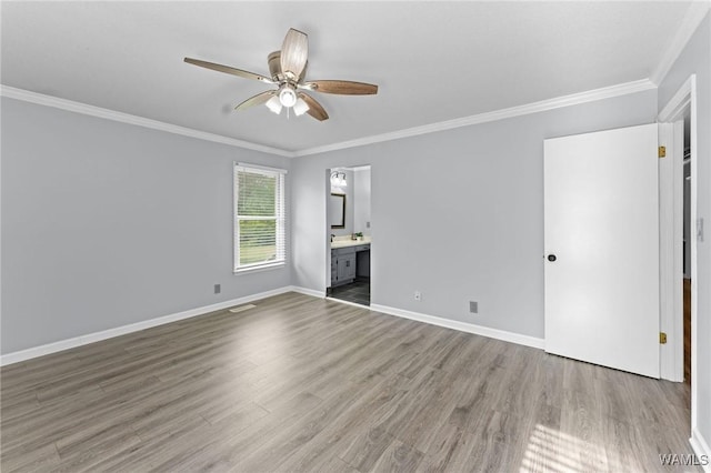 unfurnished room featuring wood finished floors, ceiling fan, and crown molding