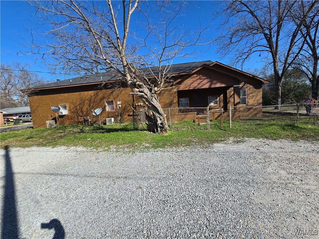 view of front of house featuring fence