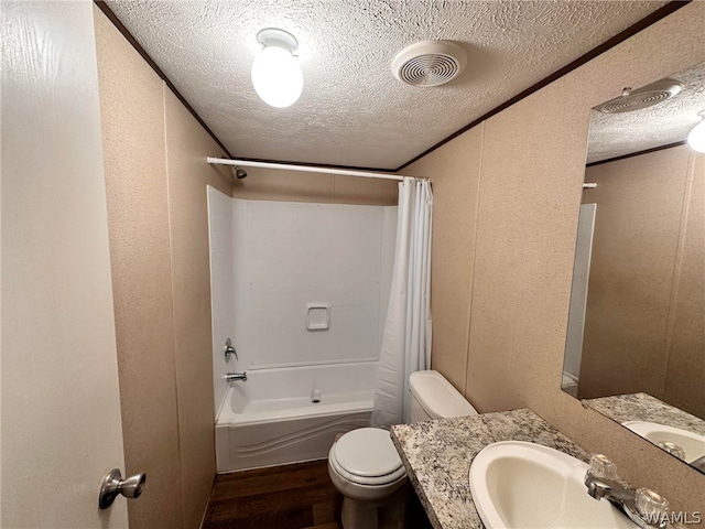 full bathroom with a textured ceiling, hardwood / wood-style flooring, and shower / bath combo with shower curtain