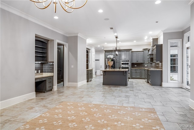 kitchen featuring pendant lighting, a center island, stainless steel appliances, and tasteful backsplash