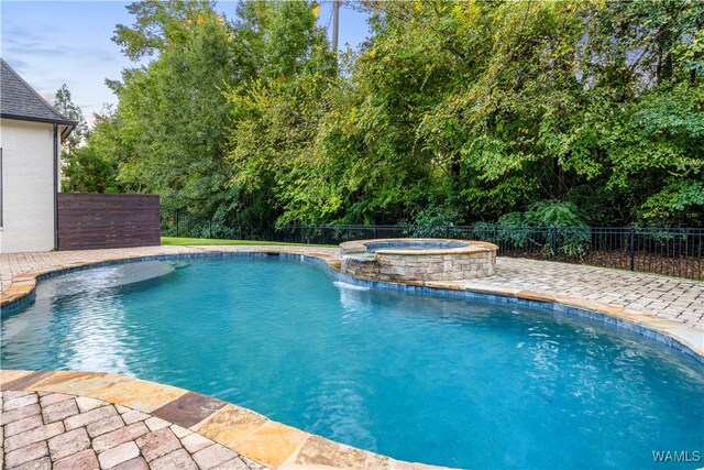 view of swimming pool with a patio area, an in ground hot tub, and pool water feature