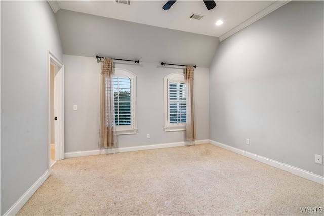 carpeted spare room with ceiling fan, lofted ceiling, and crown molding