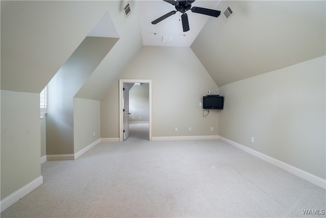 additional living space with ceiling fan, light colored carpet, and vaulted ceiling