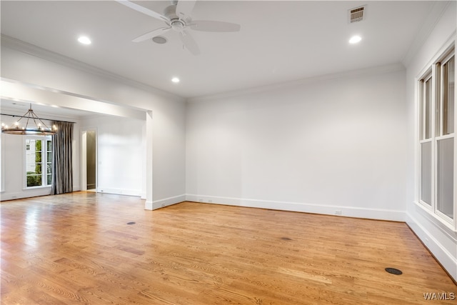 unfurnished room featuring ceiling fan with notable chandelier, light hardwood / wood-style floors, and ornamental molding