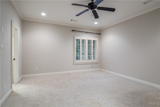 carpeted spare room with ceiling fan and crown molding