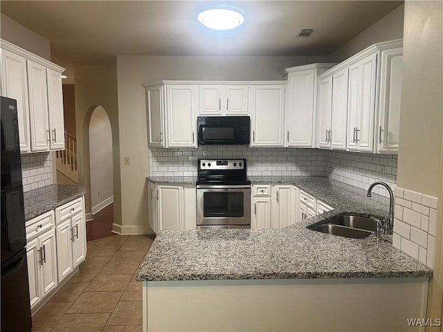 11408 Belle Meade Way, Northport, AL 35475 - kitchen with black appliances, a sink, arched walkways, decorative backsplash, and tile patterned flooring