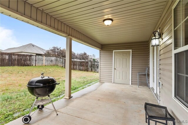 view of patio with grilling area and a fenced backyard