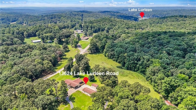 bird's eye view featuring a wooded view