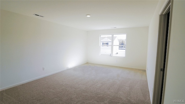 spare room with light colored carpet