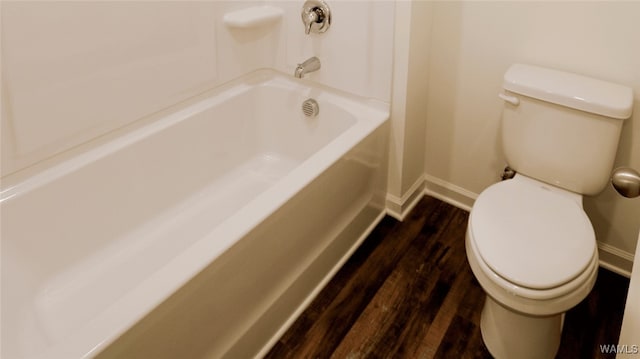 bathroom featuring a bath, wood-type flooring, and toilet