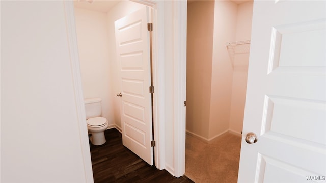 bathroom with hardwood / wood-style flooring and toilet