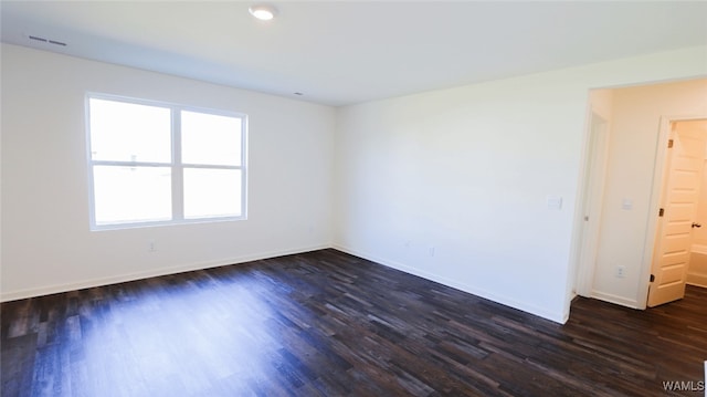 empty room with dark hardwood / wood-style flooring