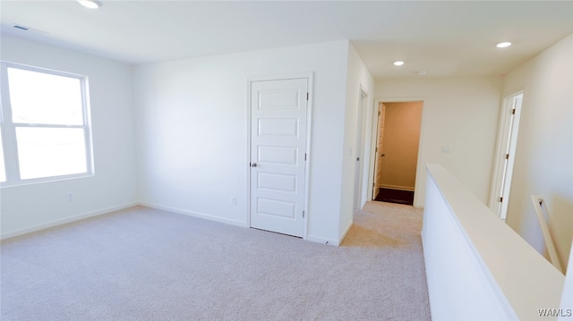 interior space featuring light carpet and a closet