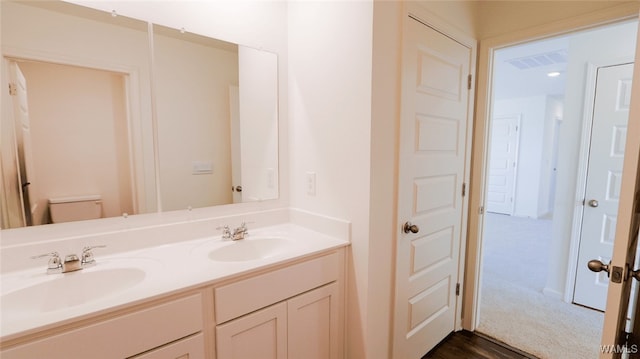 bathroom with vanity and toilet