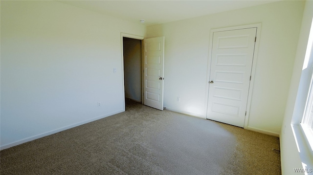 unfurnished bedroom with carpet flooring and a closet