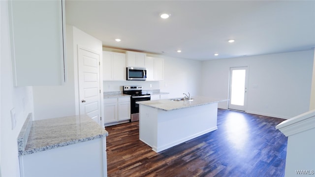 kitchen featuring light stone counters, dark wood-type flooring, white cabinets, and stainless steel appliances