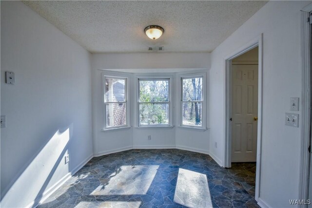 spare room featuring a textured ceiling