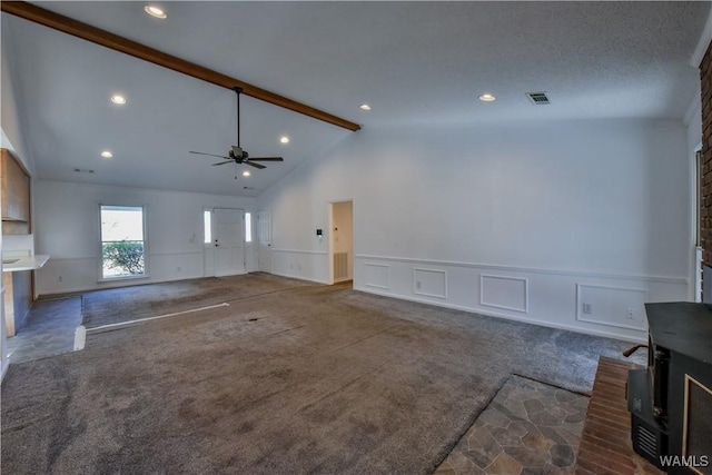 unfurnished living room featuring carpet flooring, lofted ceiling with beams, and ceiling fan