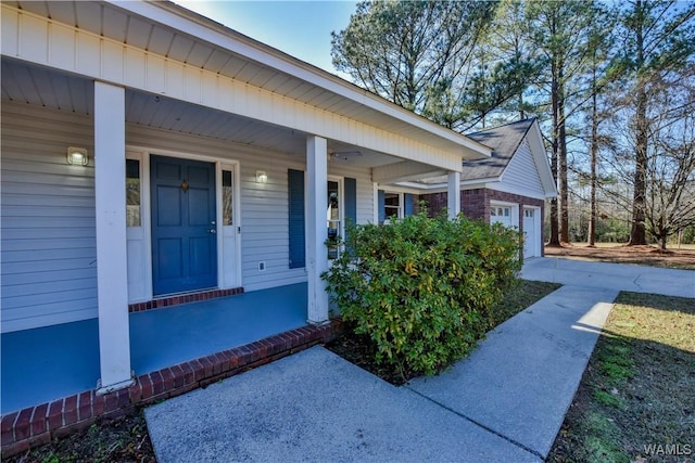 property entrance with a porch and a garage