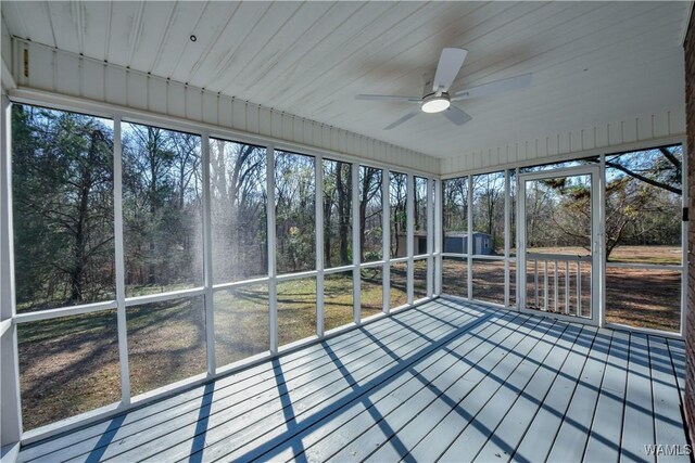 unfurnished sunroom featuring ceiling fan