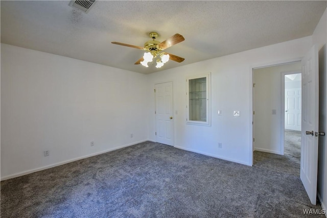 interior space featuring ceiling fan, dark carpet, and a textured ceiling