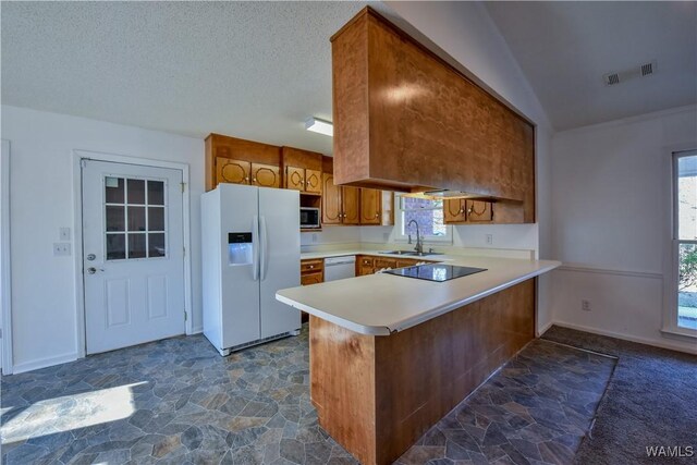 kitchen with kitchen peninsula, white appliances, plenty of natural light, and sink