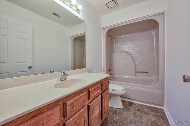 full bathroom featuring vanity, toilet, and  shower combination