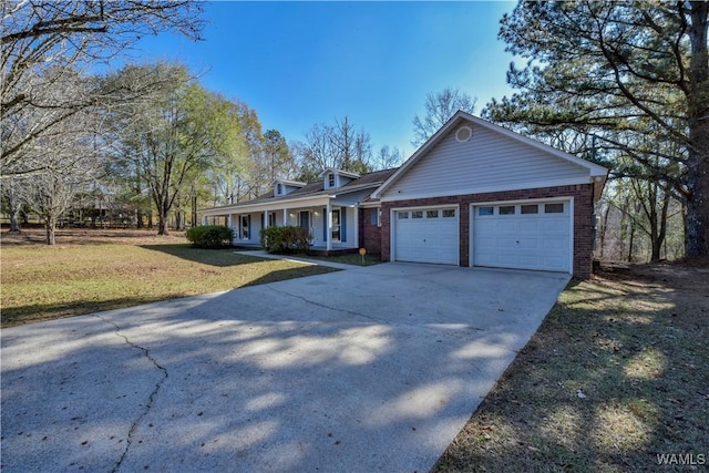 view of front of property featuring a garage, covered porch, and a front lawn