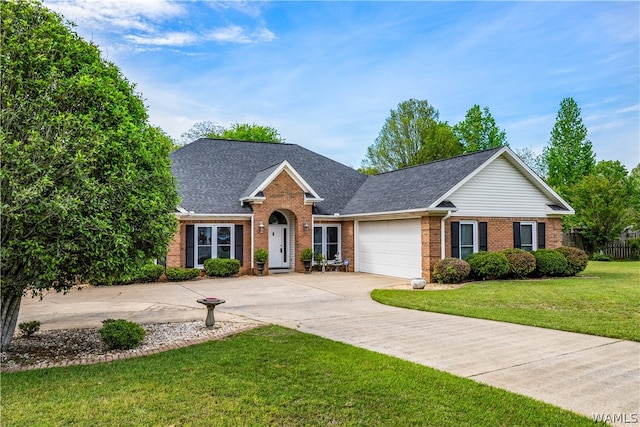 ranch-style house featuring a front yard and a garage