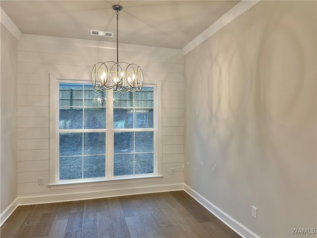 unfurnished dining area featuring a notable chandelier and dark wood-type flooring