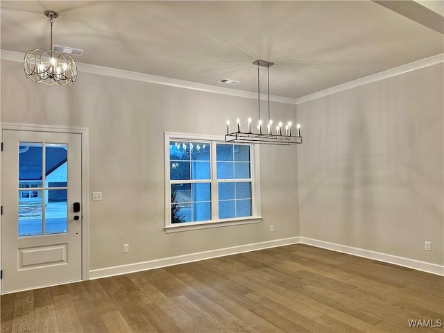 unfurnished dining area with a chandelier, wood-type flooring, and crown molding