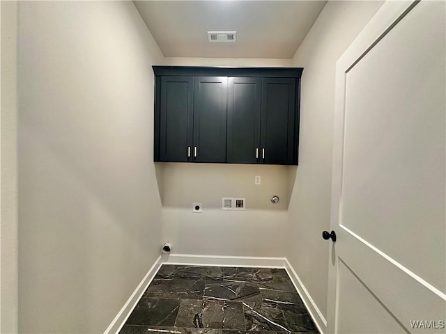 clothes washing area featuring cabinets, gas dryer hookup, washer hookup, and hookup for an electric dryer