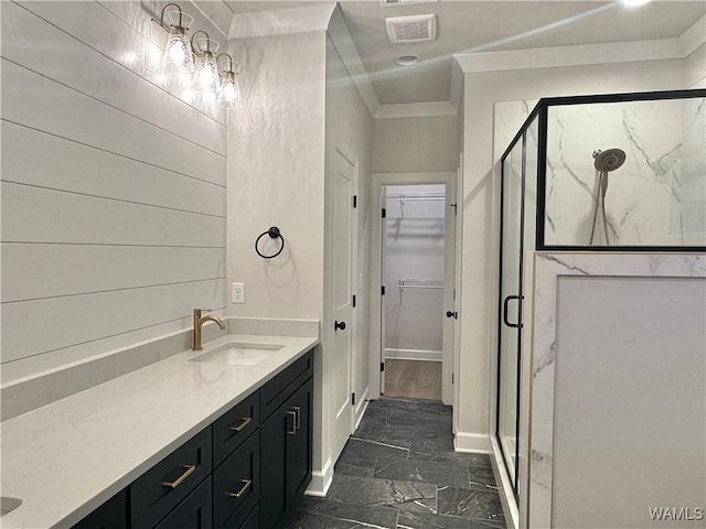 bathroom featuring vanity, an enclosed shower, and ornamental molding