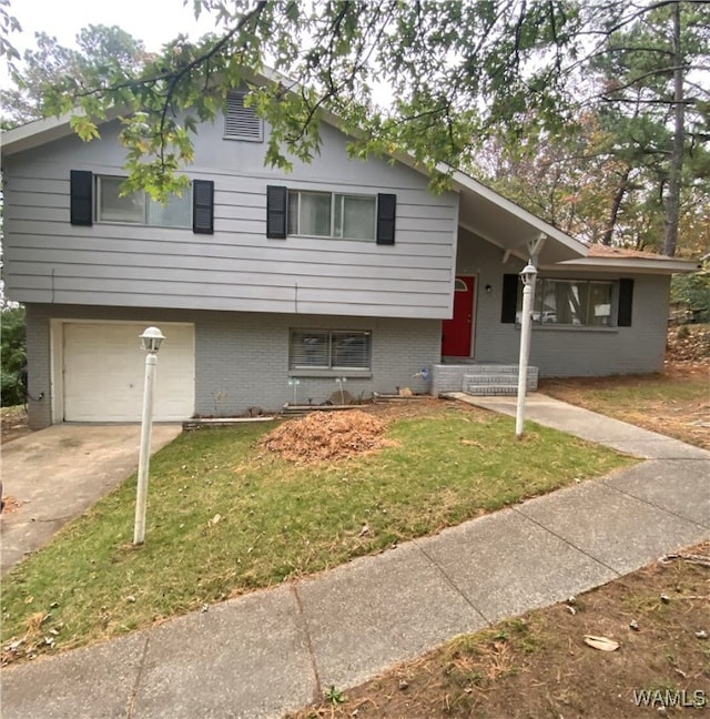 tri-level home with a garage and a front lawn