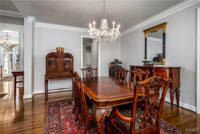 dining room featuring wood finished floors, ornate columns, and a chandelier