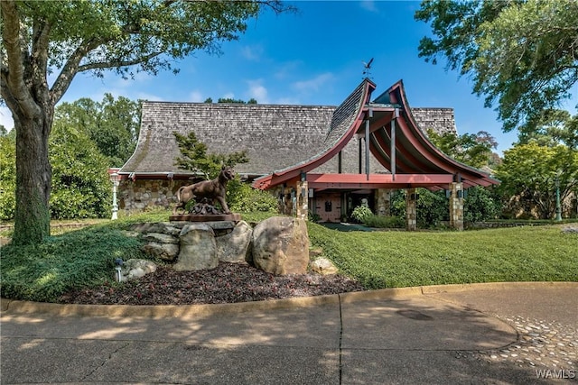 view of front of house featuring a front yard and stone siding