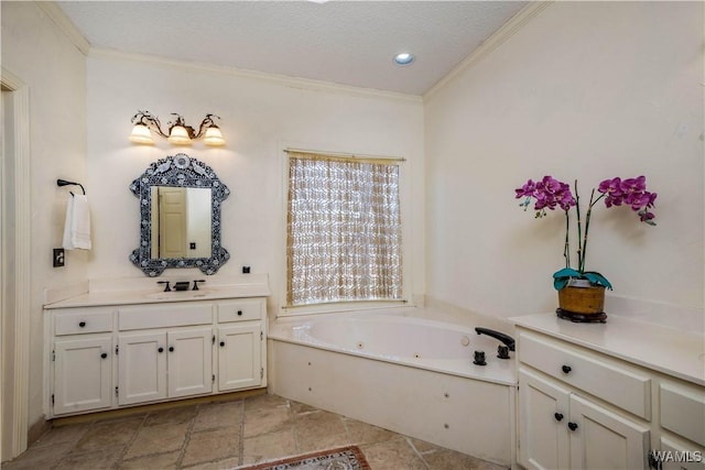 full bathroom with a textured ceiling, a tub with jets, ornamental molding, and vanity