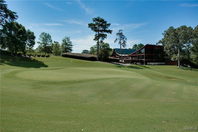 view of community with a lawn and golf course view