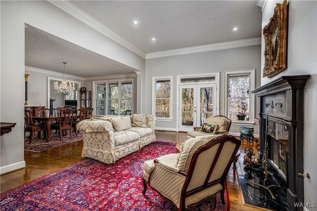 living area with a healthy amount of sunlight, a fireplace, and wood finished floors