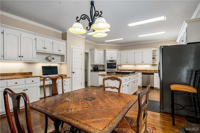 dining space with a chandelier, a textured ceiling, dark wood-style floors, and crown molding