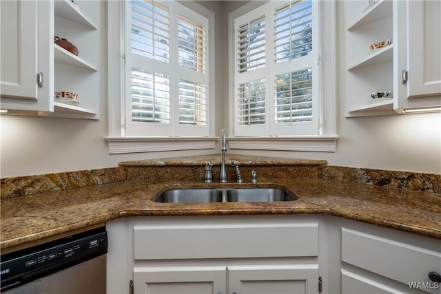 kitchen with stainless steel dishwasher, open shelves, white cabinetry, and a sink