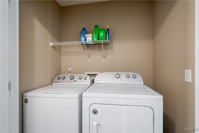 washroom featuring laundry area and washer and clothes dryer