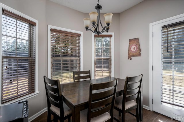 dining area with a notable chandelier, dark wood-style floors, and baseboards